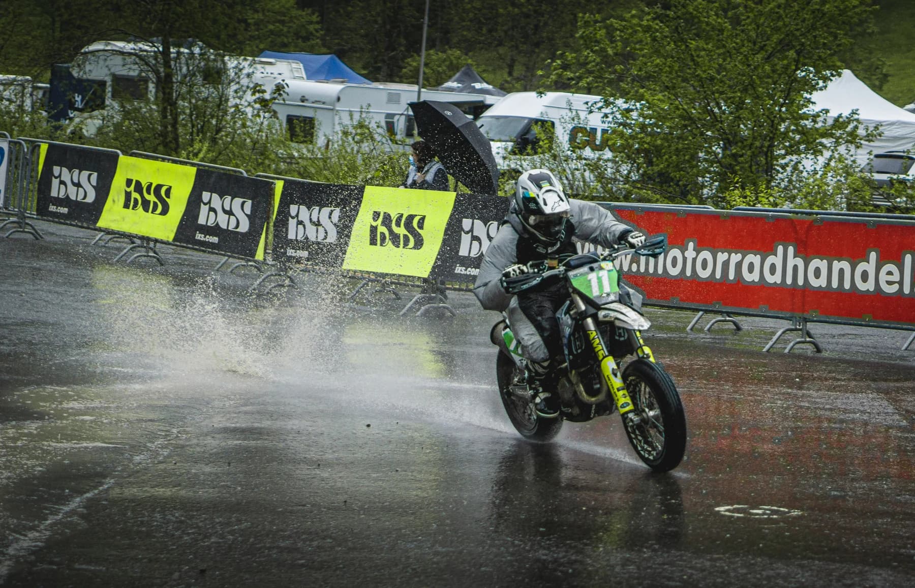 Motorradfahrer bei einer Stuntshow in einer Wasserfontäne
